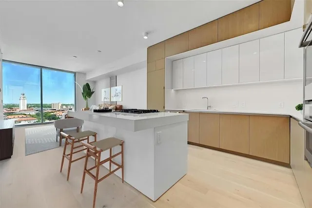 a kitchen with a sink cabinets and window