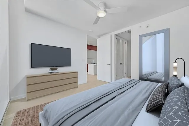 a bedroom with a bed and a flat screen tv