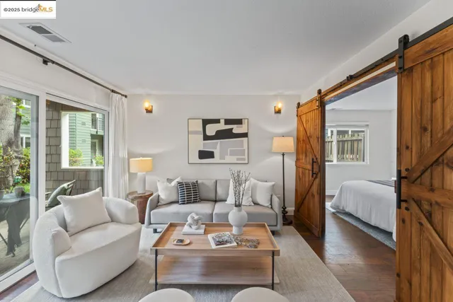 a living room with furniture a rug and a window