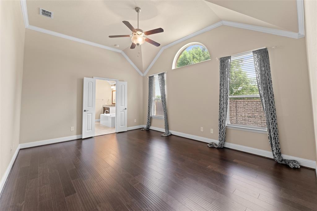 600 Fishback Circle Plano, TX 75074 - Photo 27 of 38 an empty room with wooden floor mirror and windows