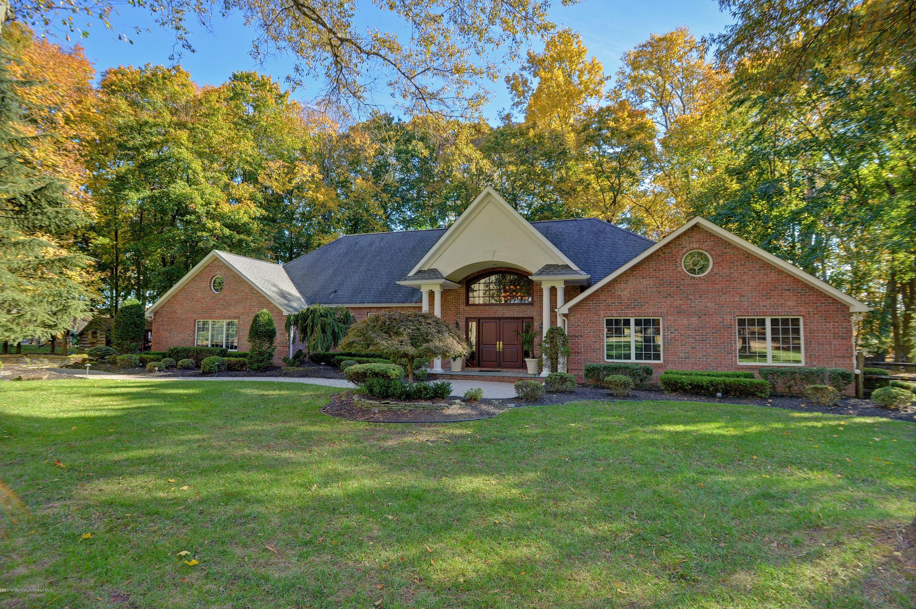 31 Beaver Dam Road Colts Neck, NJ 07722 - Photo 1 of 54 a front view of a house with yard and green space