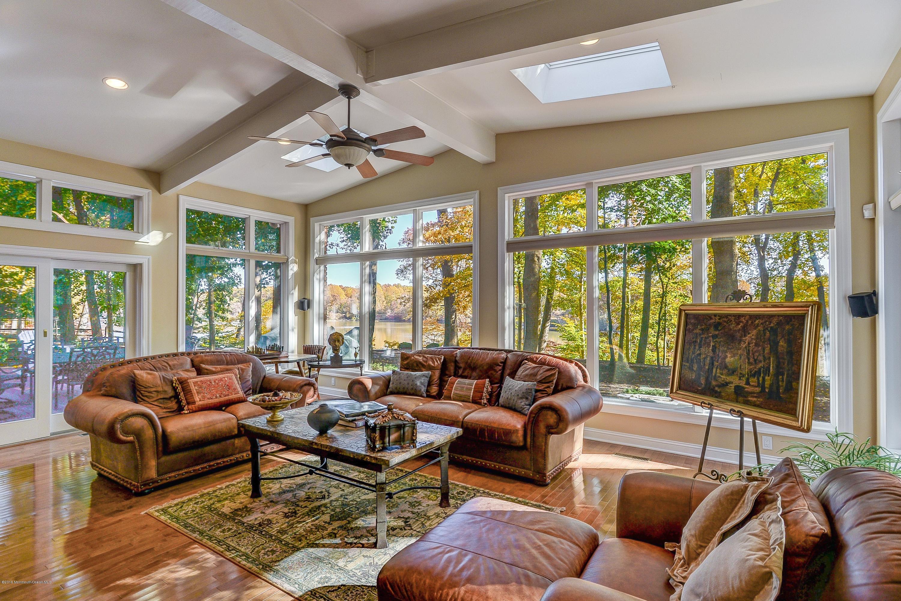 31 Beaver Dam Road Colts Neck, NJ 07722 - Photo 16 of 54 a living room with furniture and a floor to ceiling window