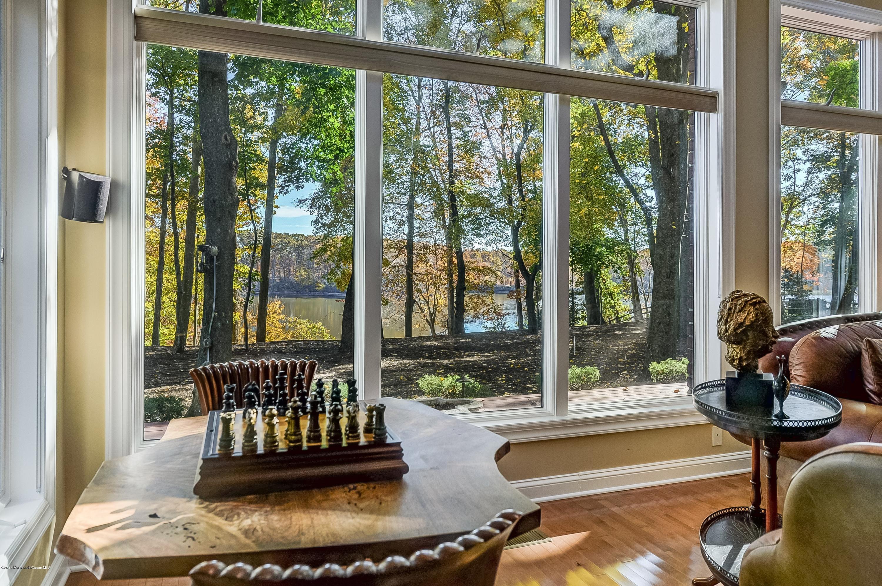 31 Beaver Dam Road Colts Neck, NJ 07722 - Photo 17 of 54 a living room with glass windows and a floor to ceiling window