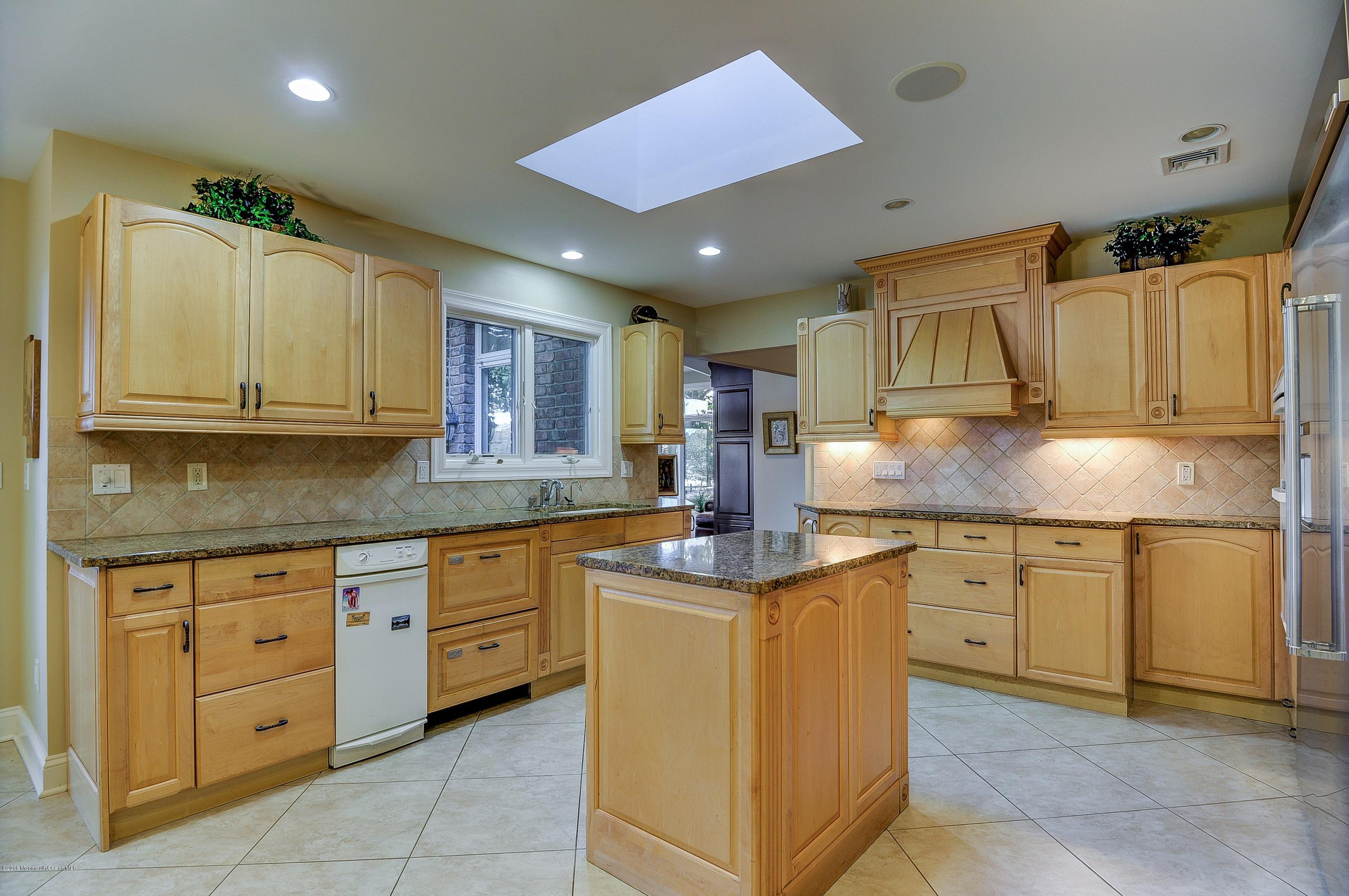 31 Beaver Dam Road Colts Neck, NJ 07722 - Photo 21 of 54 a kitchen with granite countertop a sink and cabinets