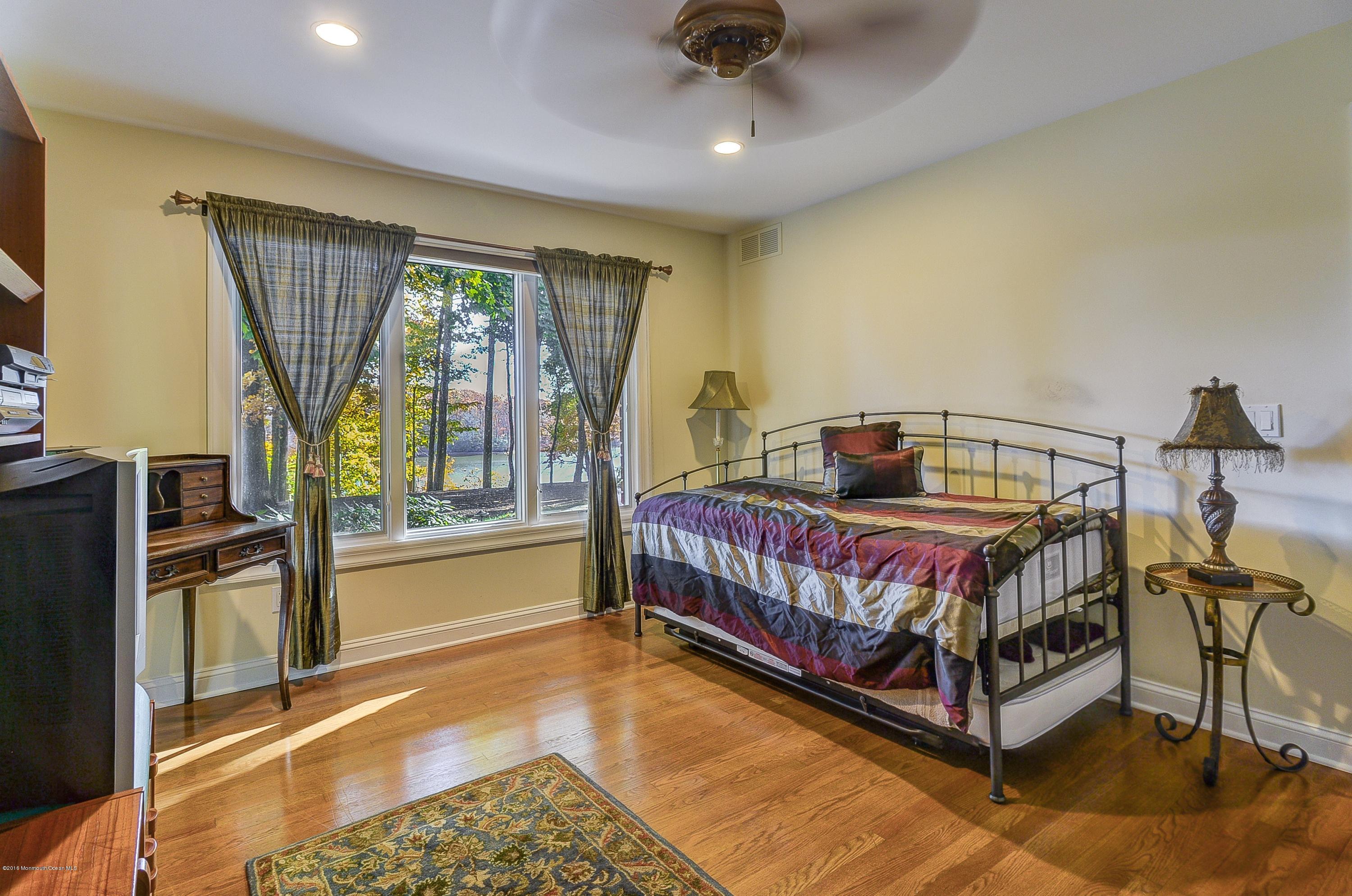 31 Beaver Dam Road Colts Neck, NJ 07722 - Photo 28 of 54 a bedroom with a bed and wooden floor
