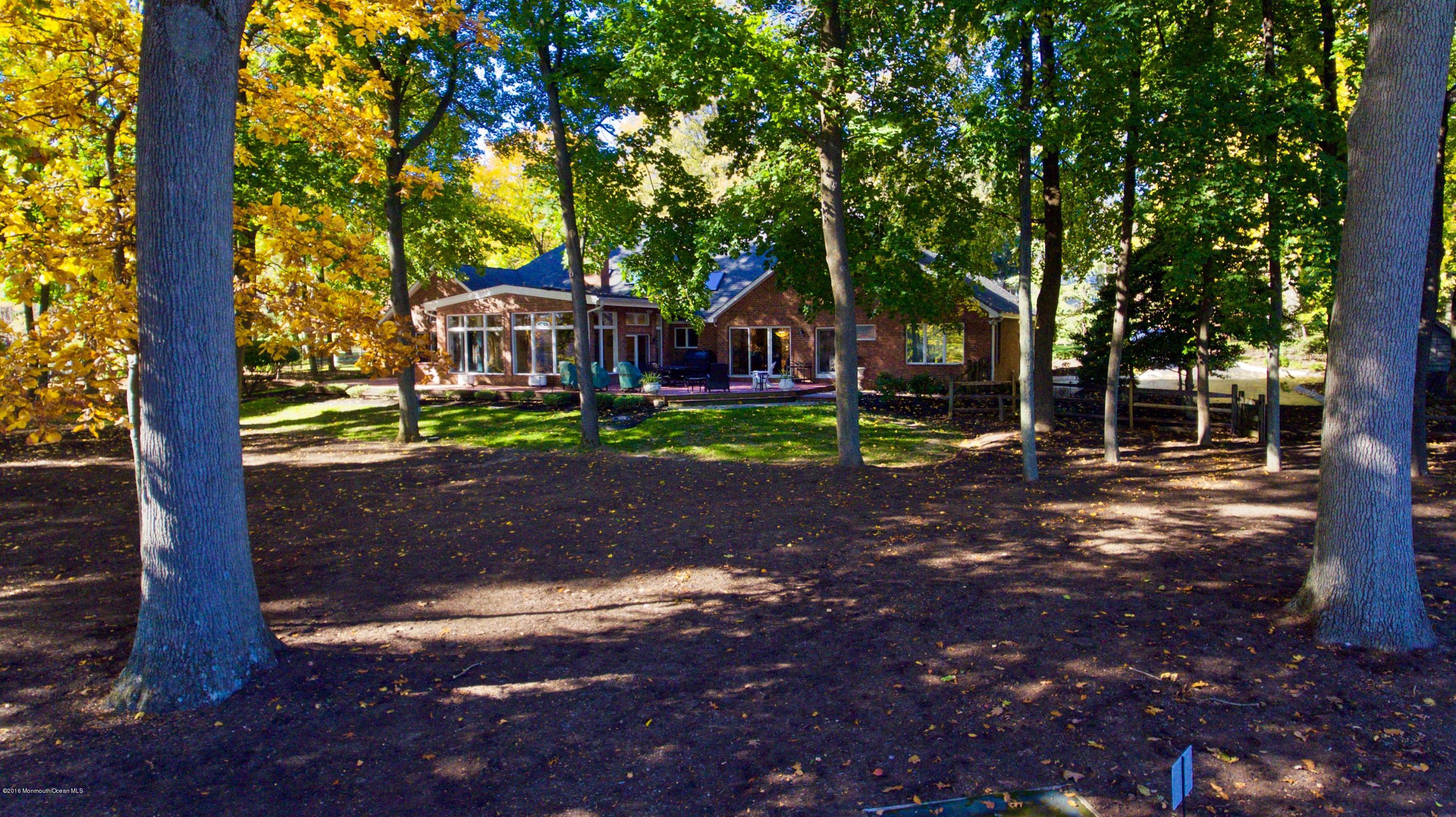 31 Beaver Dam Road Colts Neck, NJ 07722 - Photo 38 of 54 a front view of a house with a yard
