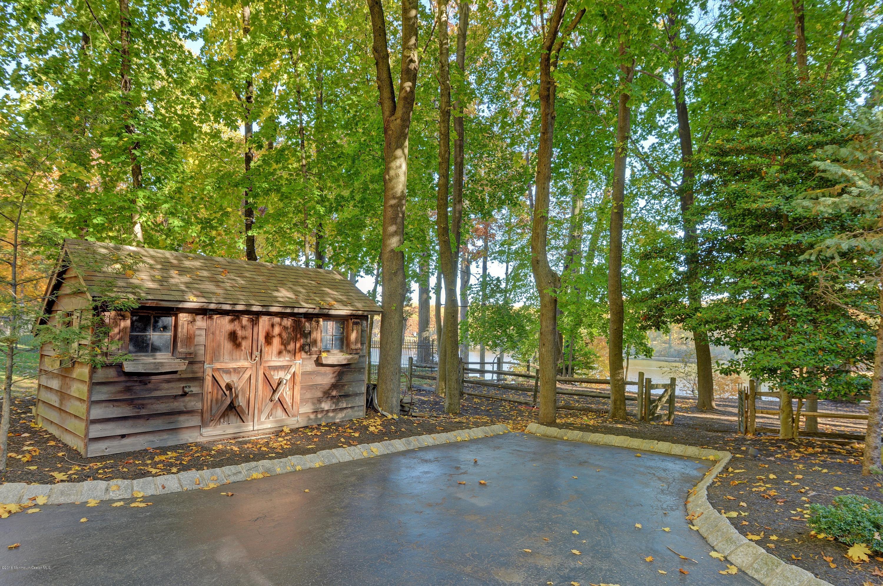 31 Beaver Dam Road Colts Neck, NJ 07722 - Photo 43 of 54 a view of a house with large tree and wooden fence