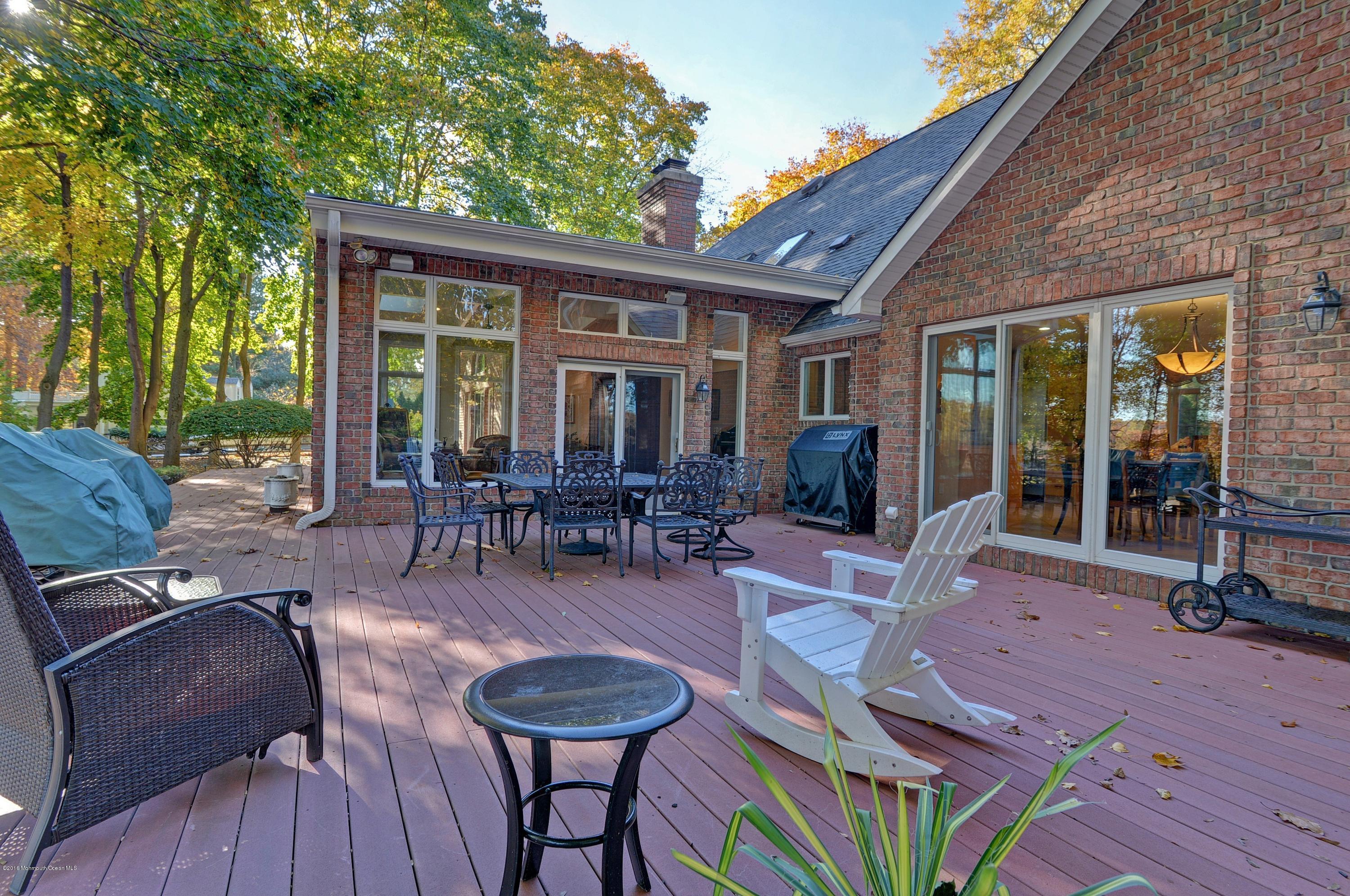 31 Beaver Dam Road Colts Neck, NJ 07722 - Photo 45 of 54 a view of a patio with table and chairs potted plants and large tree