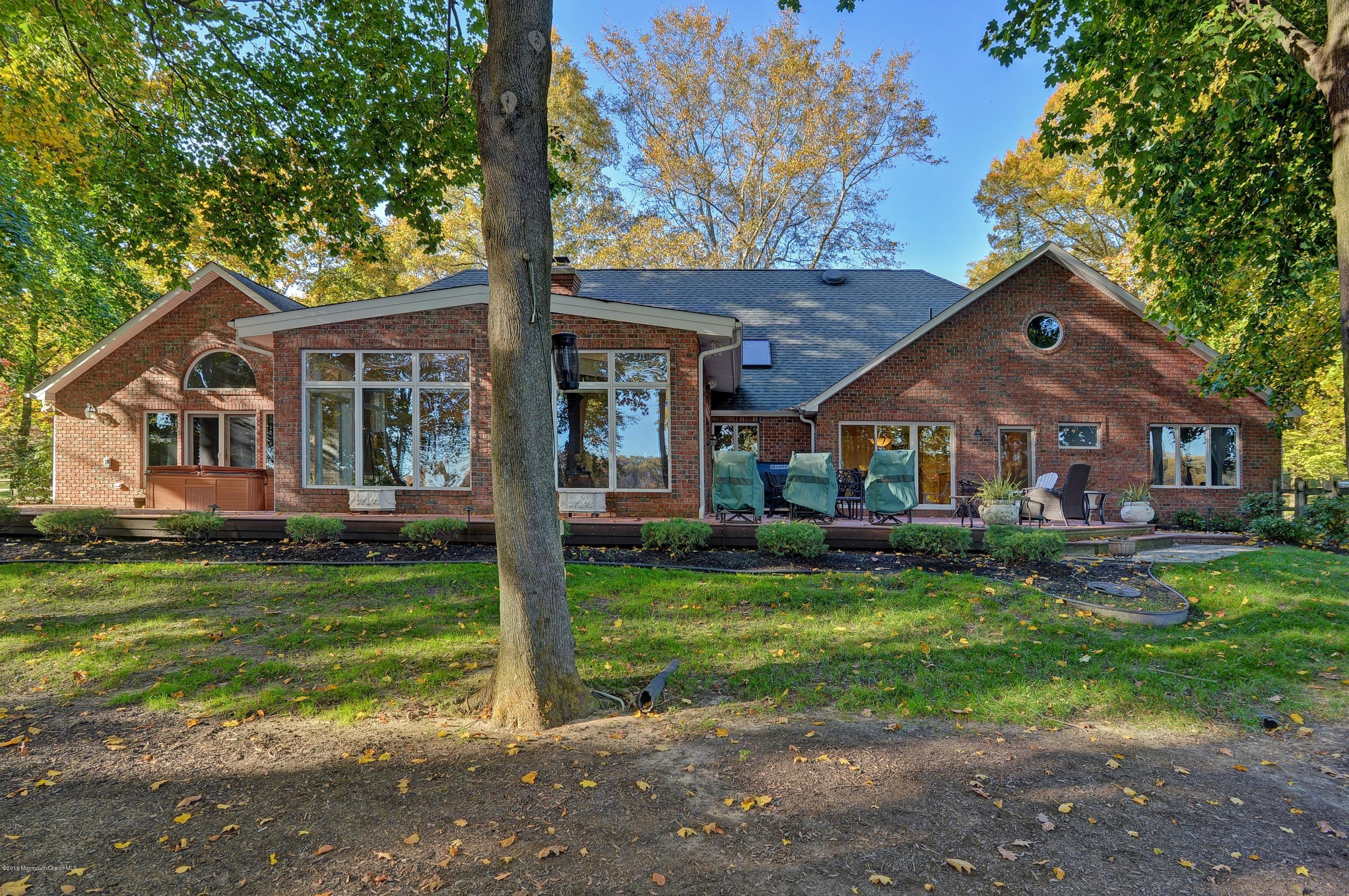 31 Beaver Dam Road Colts Neck, NJ 07722 - Photo 46 of 54 a front view of a house with a garden and porch