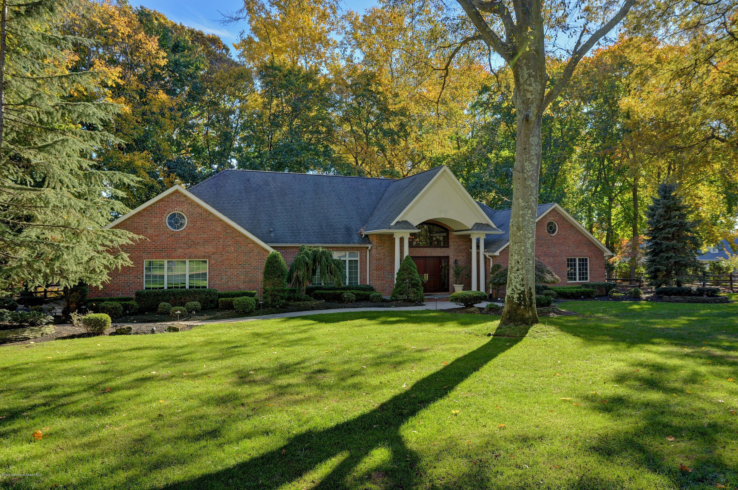31 Beaver Dam Road Colts Neck, NJ 07722 - Photo 52 of 54 a front view of a house with a yard and trees