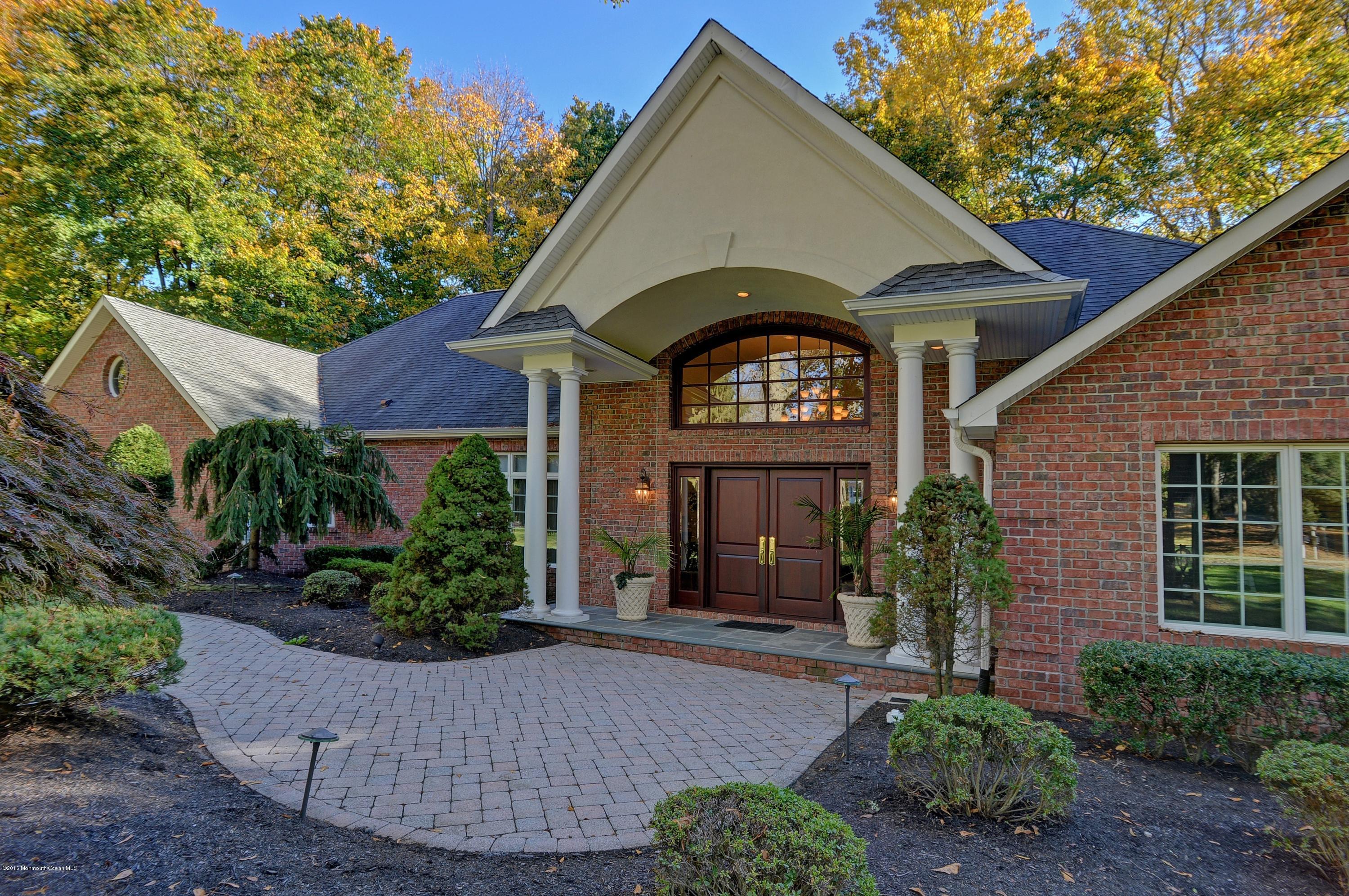 31 Beaver Dam Road Colts Neck, NJ 07722 - Photo 7 of 54 a front view of a house with a yard