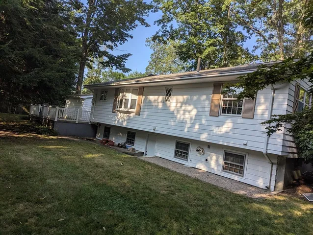 a view of house with a yard