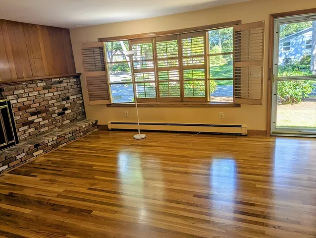 a view of a room with wooden floor and windows