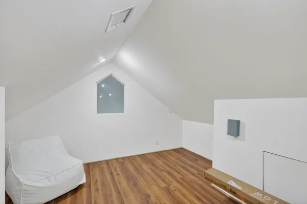 a view of empty room with wooden floor