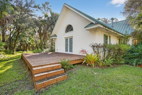 a view of a house with a yard and sitting area