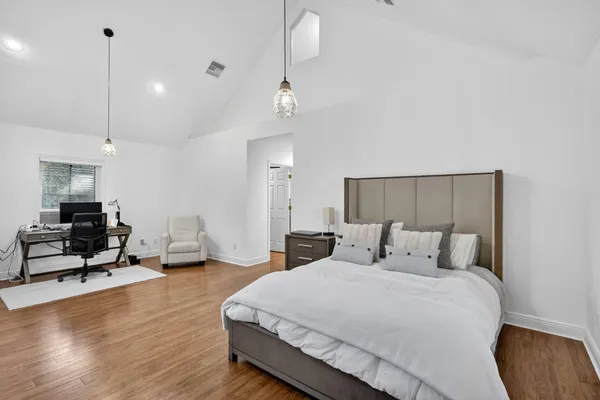 a bedroom with a bed and window