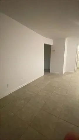 a view of an empty room and entryway