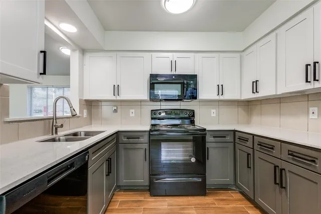 a kitchen with stainless steel appliances granite countertop a sink and stove top oven