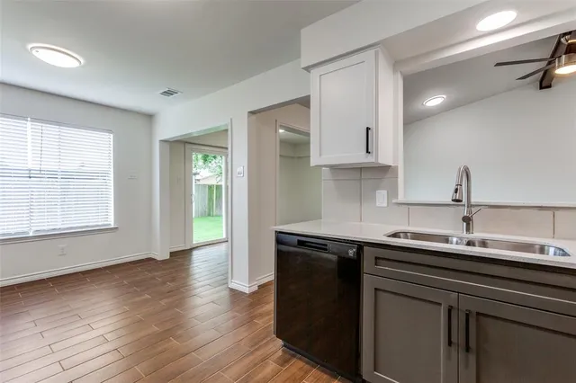 a kitchen with a sink and cabinets