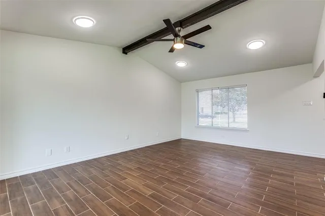 an empty room with a empty space and windows