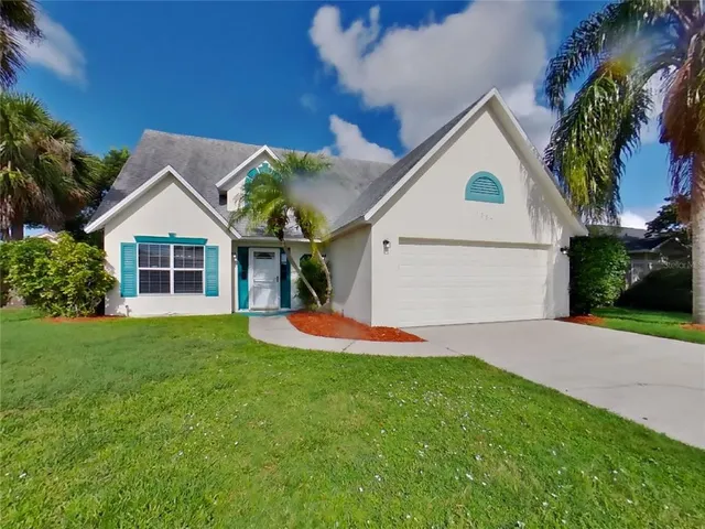 a view of a house with a yard and garage