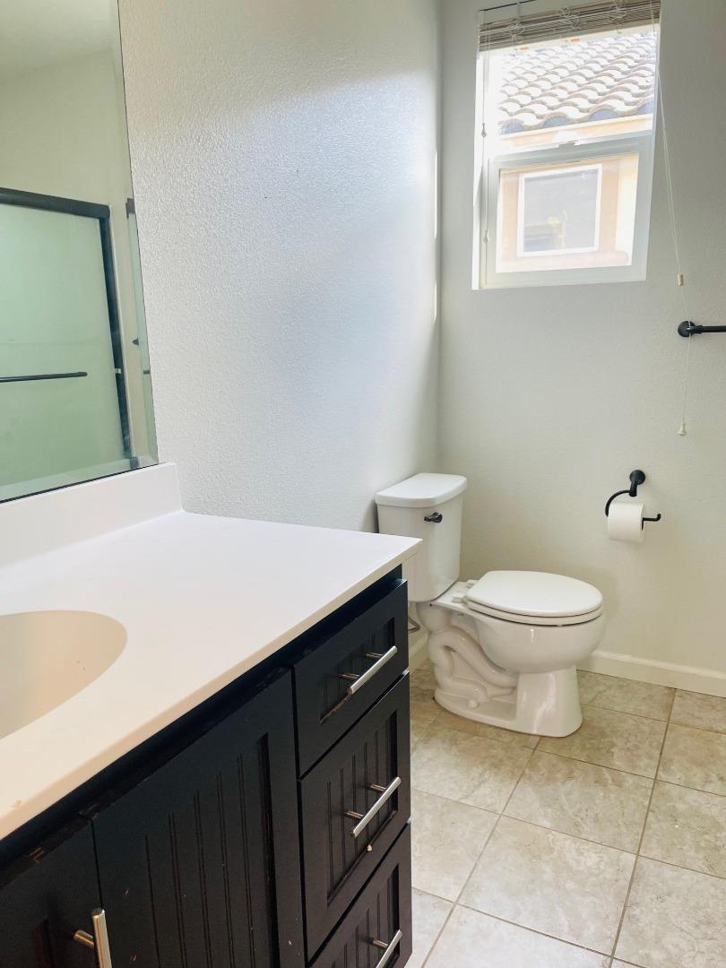 74 Caspian Way Gilroy, CA 95020 - Photo 15 of 18 a bathroom with a sink a toilet and a mirror