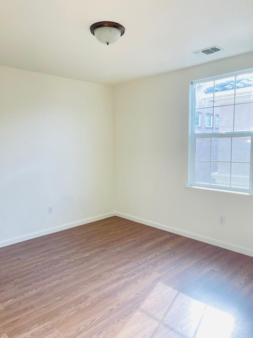 74 Caspian Way Gilroy, CA 95020 - Photo 17 of 18 wooden floor in an empty room with a window