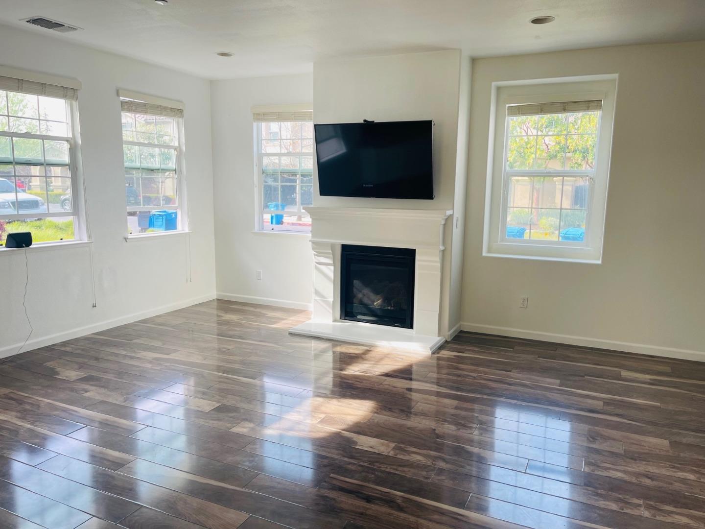 74 Caspian Way Gilroy, CA 95020 - Photo 2 of 18 a view of empty room with wooden floor and fireplace