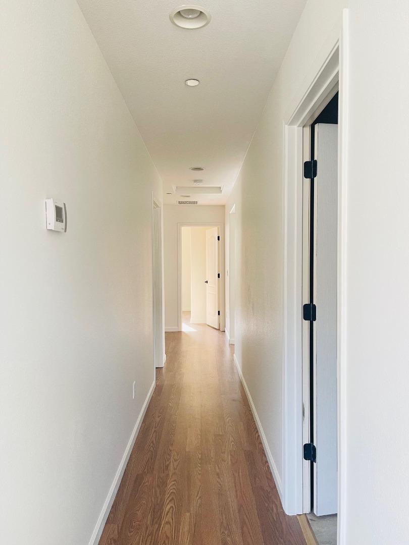 74 Caspian Way Gilroy, CA 95020 - Photo 8 of 18 a view of a hallway with wooden floor and staircase