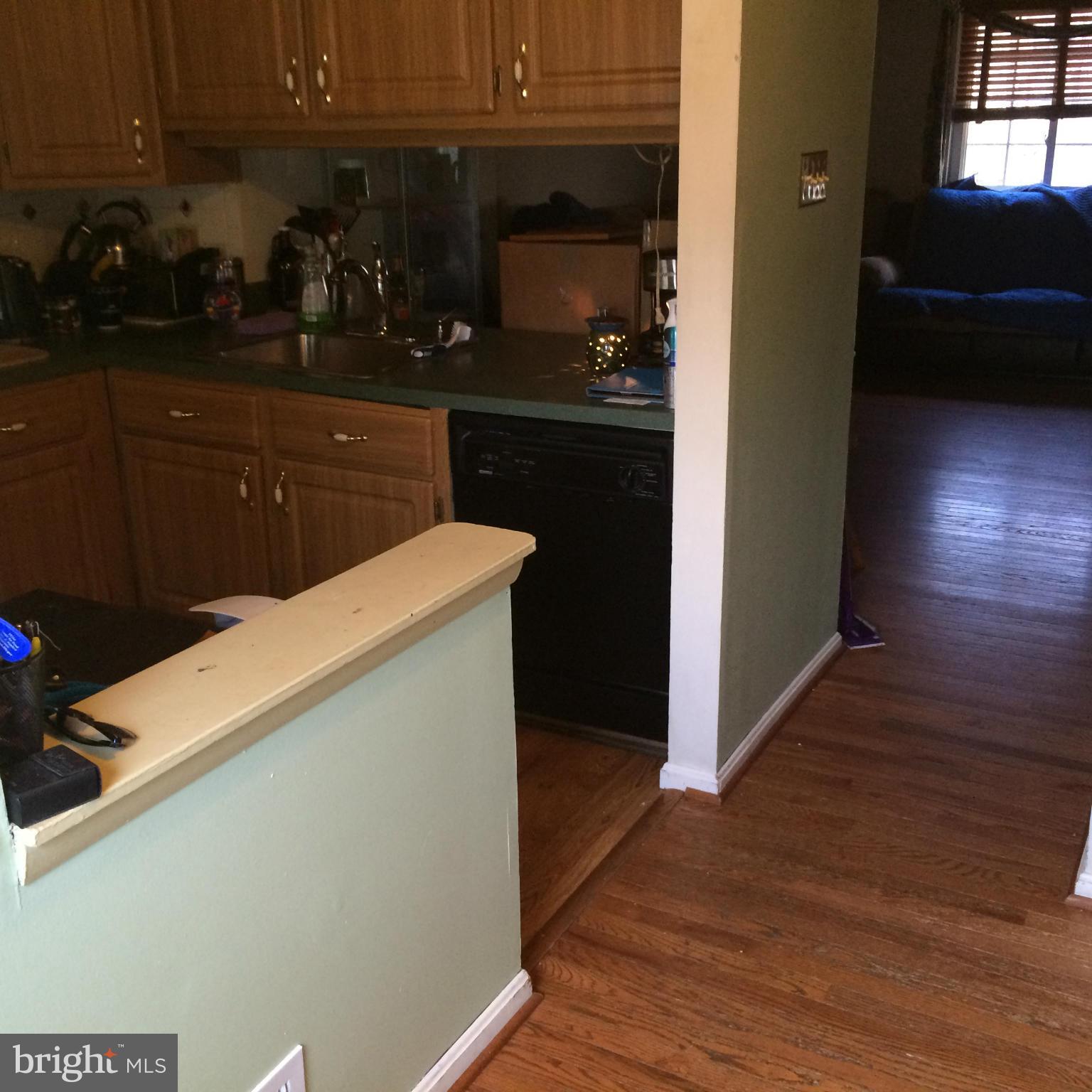 8094 Grandview Court Springfield, VA 22153 - Photo 2 of 13 a kitchen with a refrigerator and cabinets