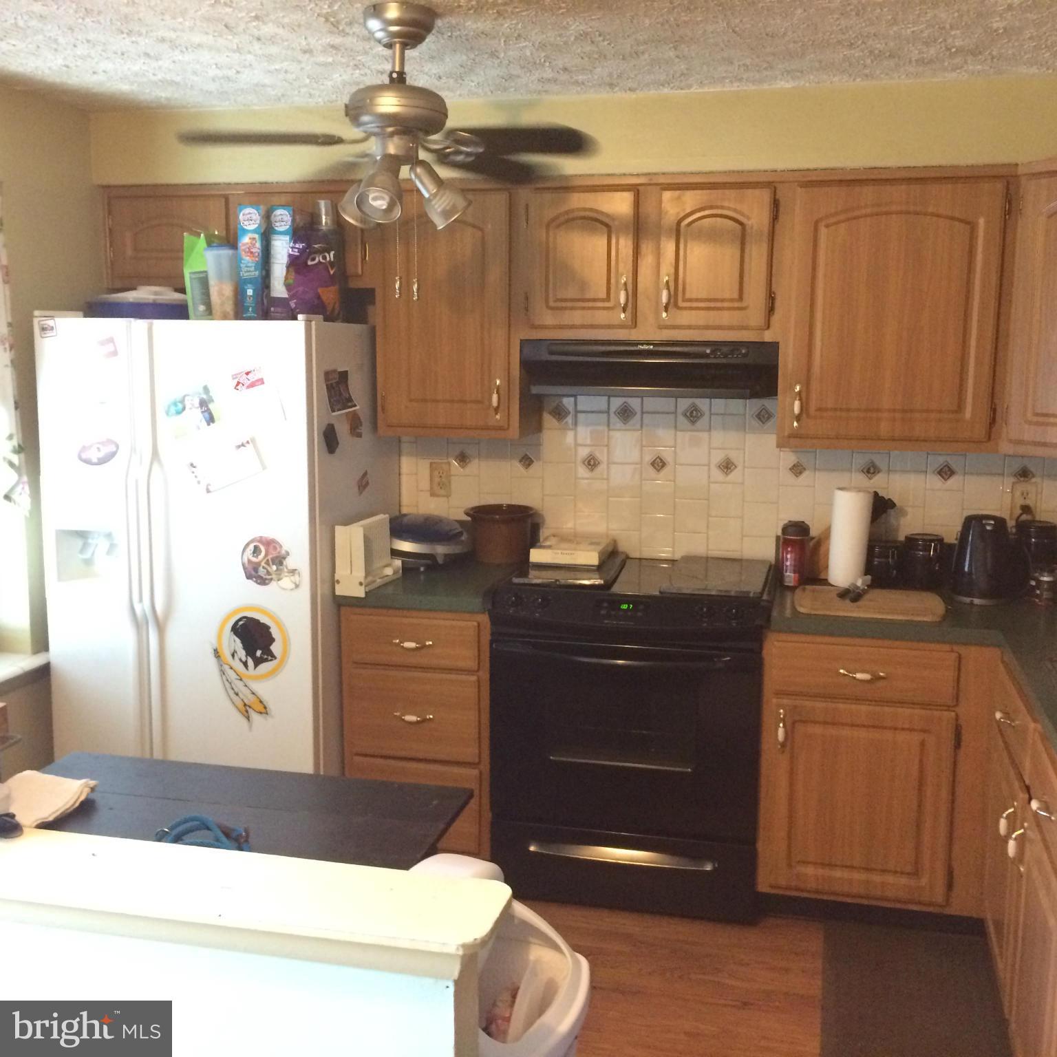 8094 Grandview Court Springfield, VA 22153 - Photo 3 of 13 a kitchen with stainless steel appliances granite countertop a refrigerator and a stove