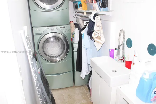a kitchen with a refrigerator and a stove top open