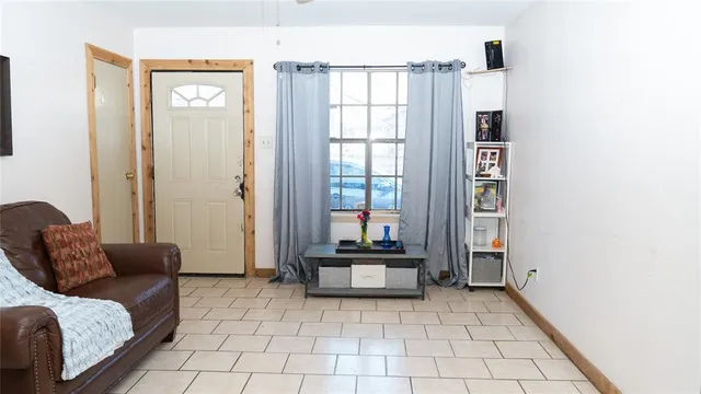 a living room with furniture and a floor to ceiling window