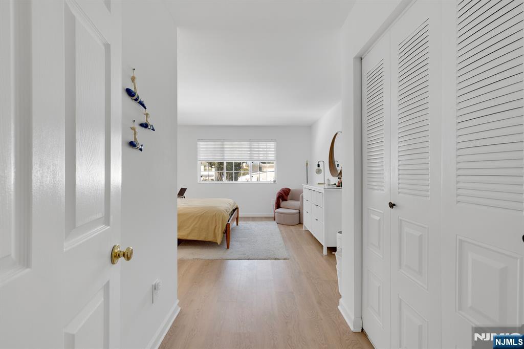 199 Union Avenue, Unit 2F Rutherford, NJ 07070 - Photo 13 of 25 a hallway with couch and wooden floor