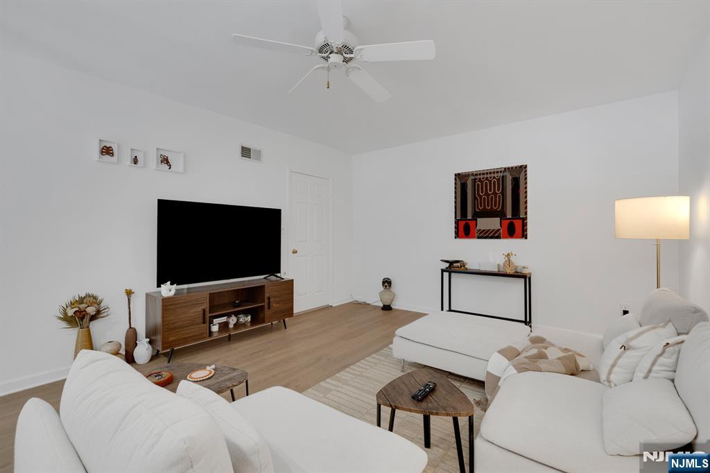 199 Union Avenue, Unit 2F Rutherford, NJ 07070 - Photo 20 of 25 a living room with furniture and a flat screen tv