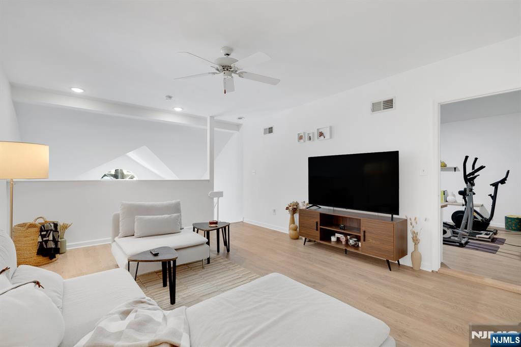 199 Union Avenue, Unit 2F Rutherford, NJ 07070 - Photo 21 of 25 a living room with furniture and a flat screen tv