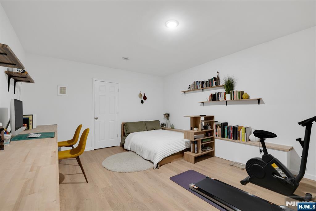 199 Union Avenue, Unit 2F Rutherford, NJ 07070 - Photo 22 of 25 a bedroom with furniture and a wooden floor