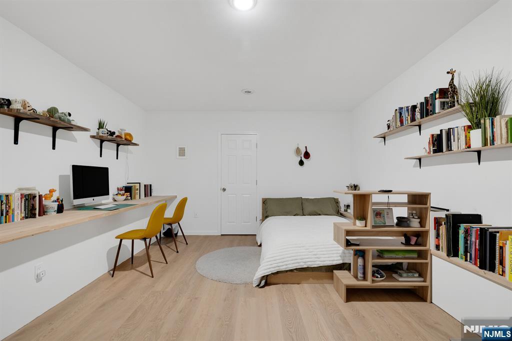 199 Union Avenue, Unit 2F Rutherford, NJ 07070 - Photo 23 of 25 a living room with furniture and a flat screen tv