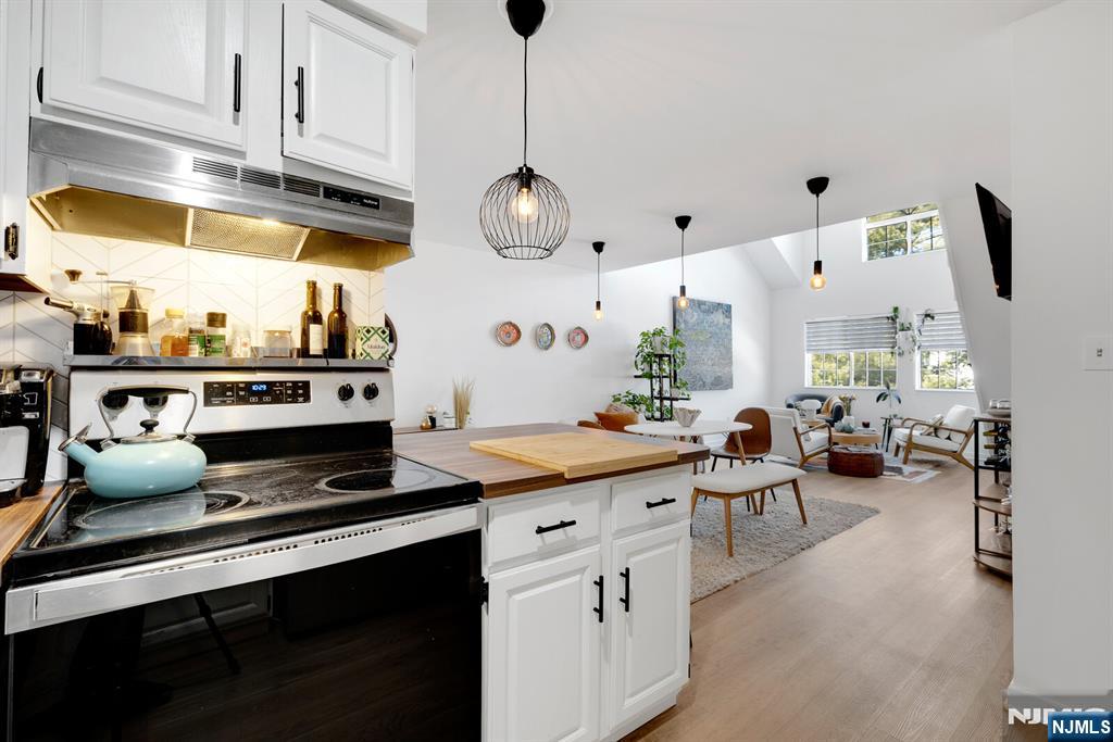 199 Union Avenue, Unit 2F Rutherford, NJ 07070 - Photo 7 of 25 a kitchen with stainless steel appliances granite countertop a stove and white cabinets