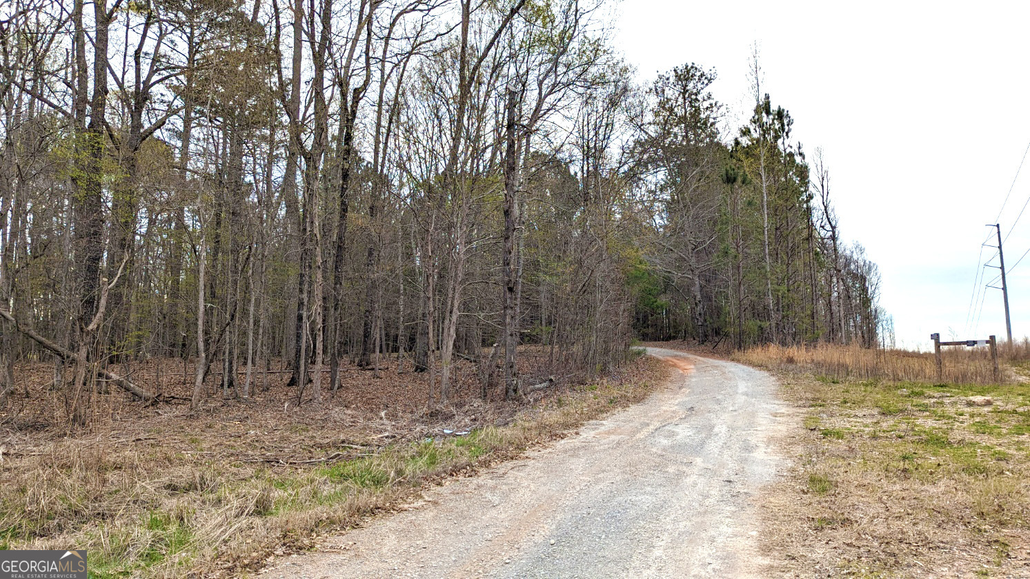 0 Hathcock Road, Unit TRACT 1 South Fulton, GA 30349 - Photo 2 of 4 Gravel road entrance leading into the 7-acre CUP-zoned land tract in South Fulton, GA. Mature hardwoods, utility access, and natural buffers make this property ideal for residential or small-scale development near Atlanta and ATL Airport.