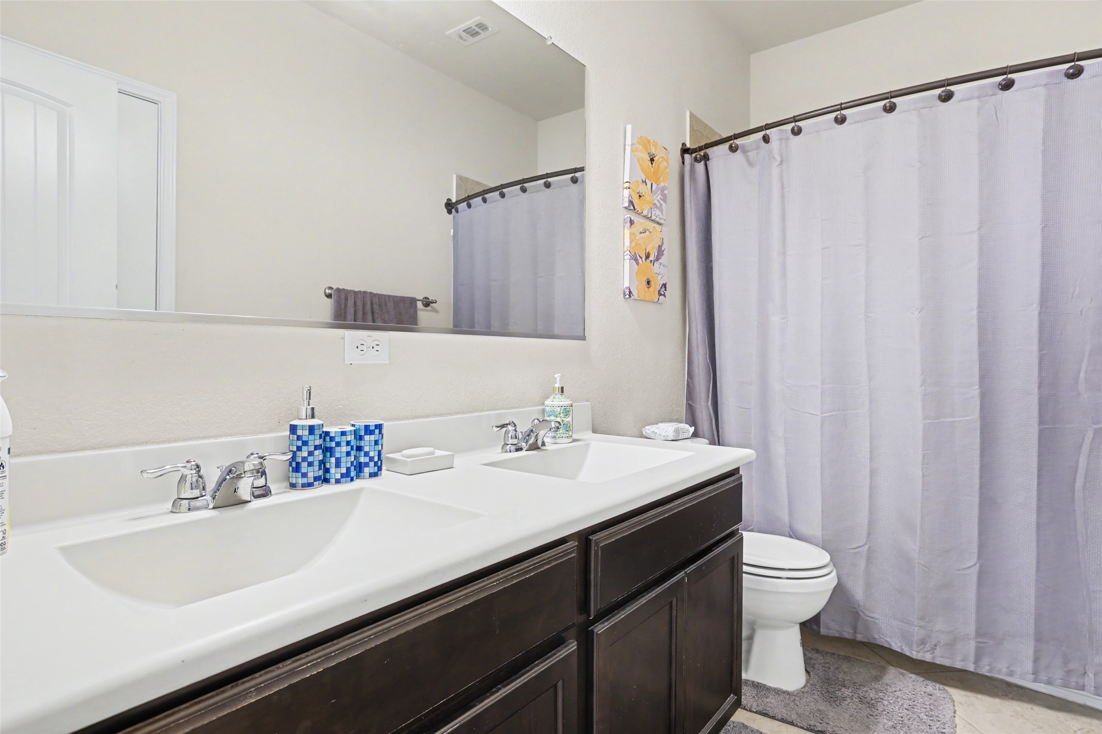 5845 Kleberg Trail Austin, TX 78747 - Photo 17 of 30 a bathroom with a sink a toilet and a mirror