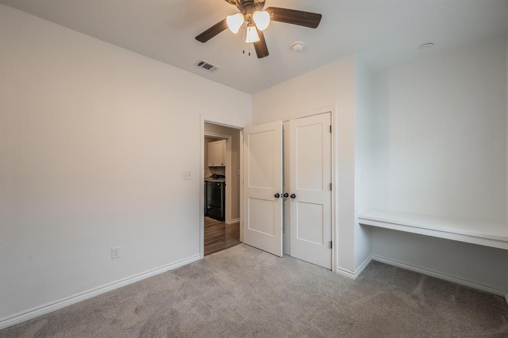 405 Dallas Street Rice, TX 75155 - Photo 23 of 40 an empty room with chandelier fan and closet area