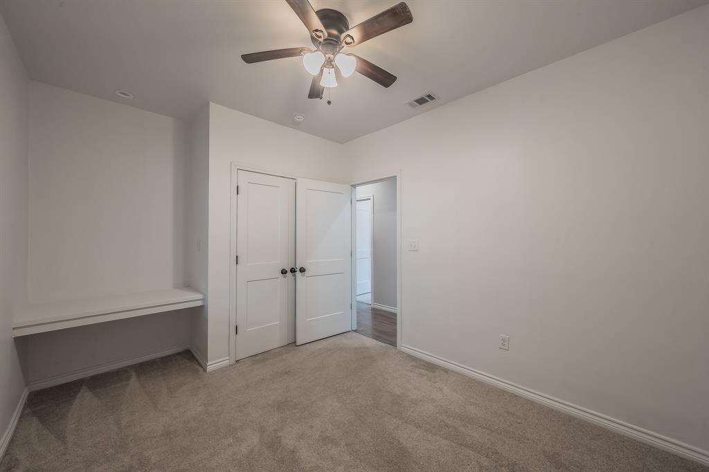 405 Dallas Street Rice, TX 75155 - Photo 26 of 40 an empty room with chandelier fan and windows