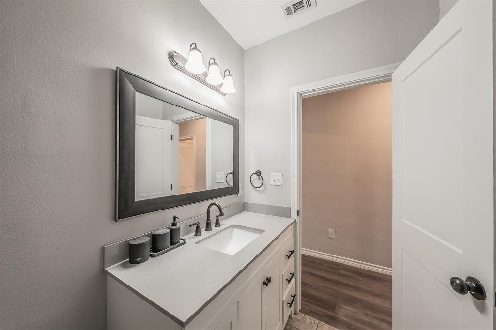 405 Dallas Street Rice, TX 75155 - Photo 29 of 40 a bathroom with a sink and a mirror