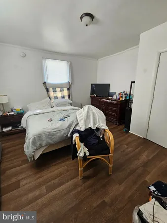a bedroom with bed chair and window