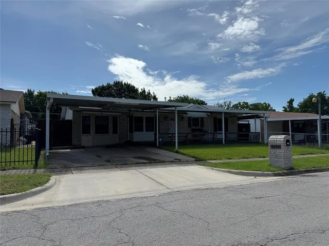 a view of a house with a yard and large trees