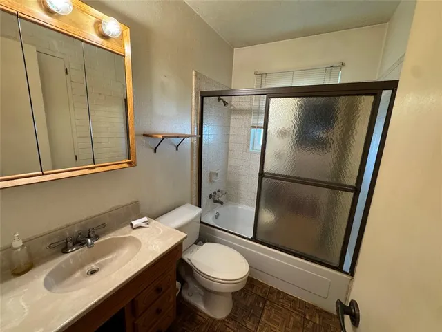 a room with furniture a flat screen tv and a window