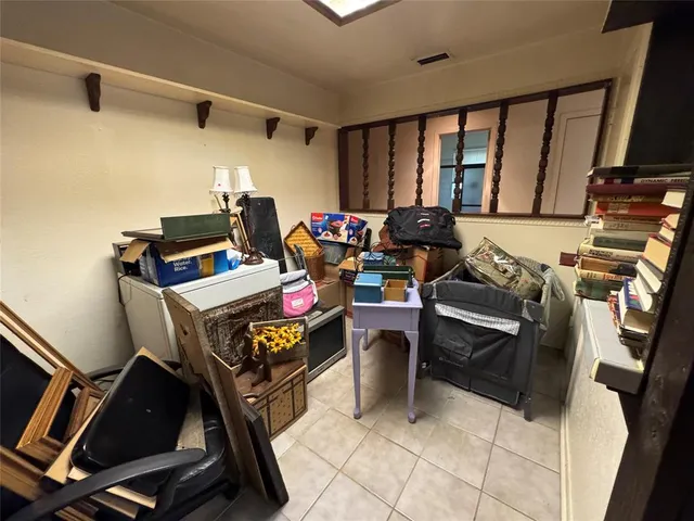an empty room with windows and fireplace