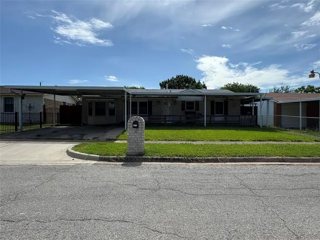 a view of a house with a swimming pool and a yard