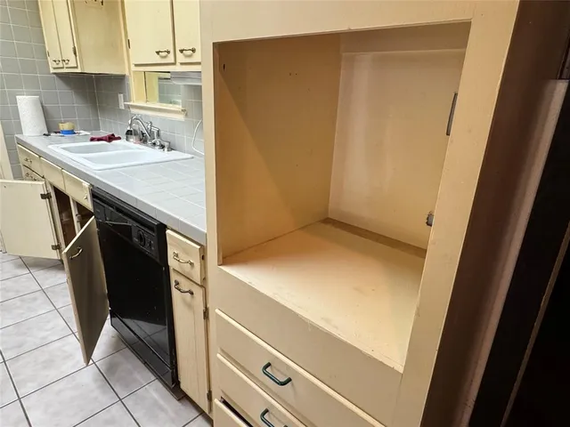 a kitchen with a sink and a refrigerator
